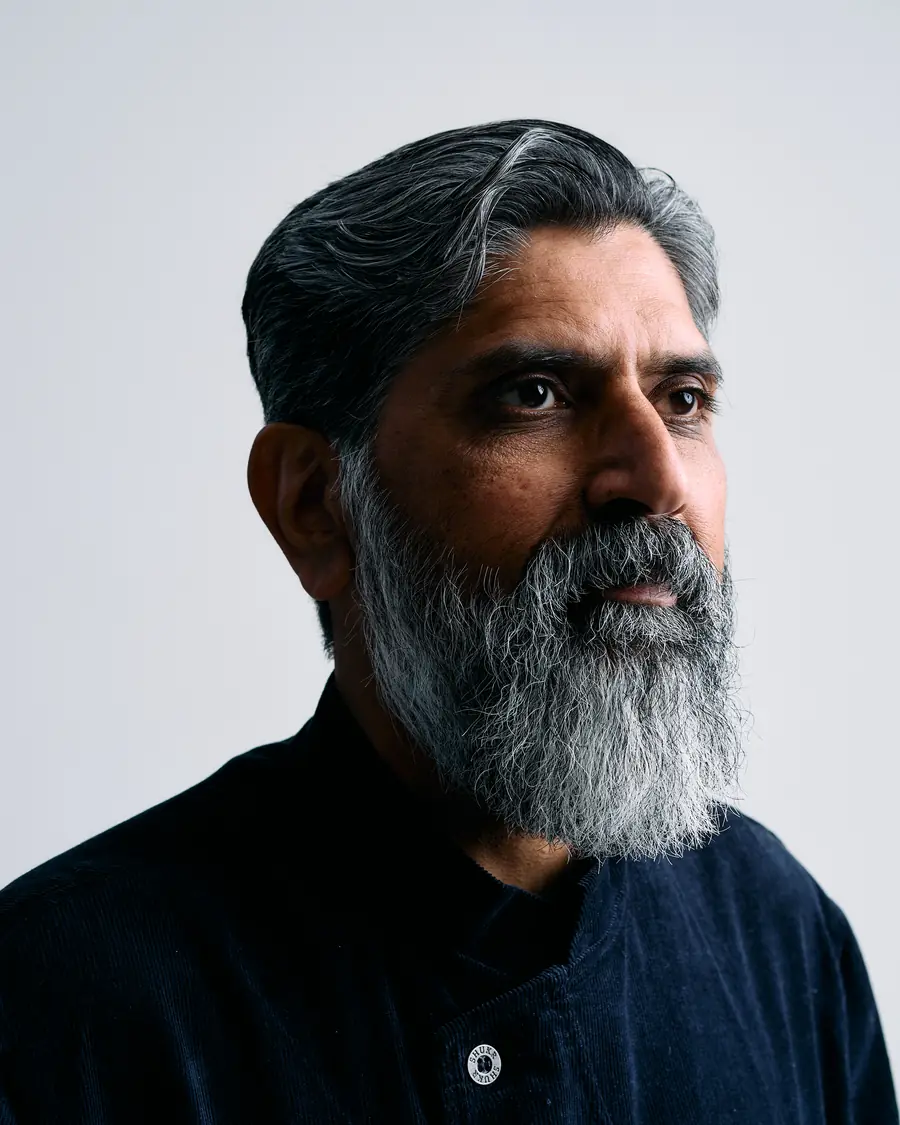 Portrait of Dr. Yasin Choudry, contemplative, in a dark coat.